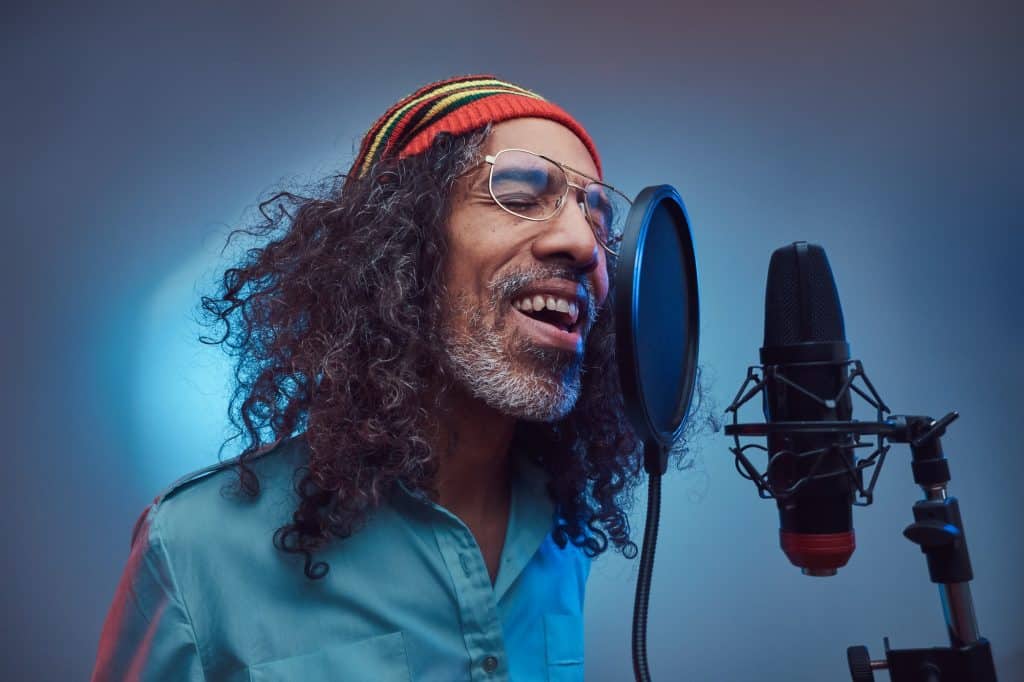 African Rastafarian singer male in the recording studio